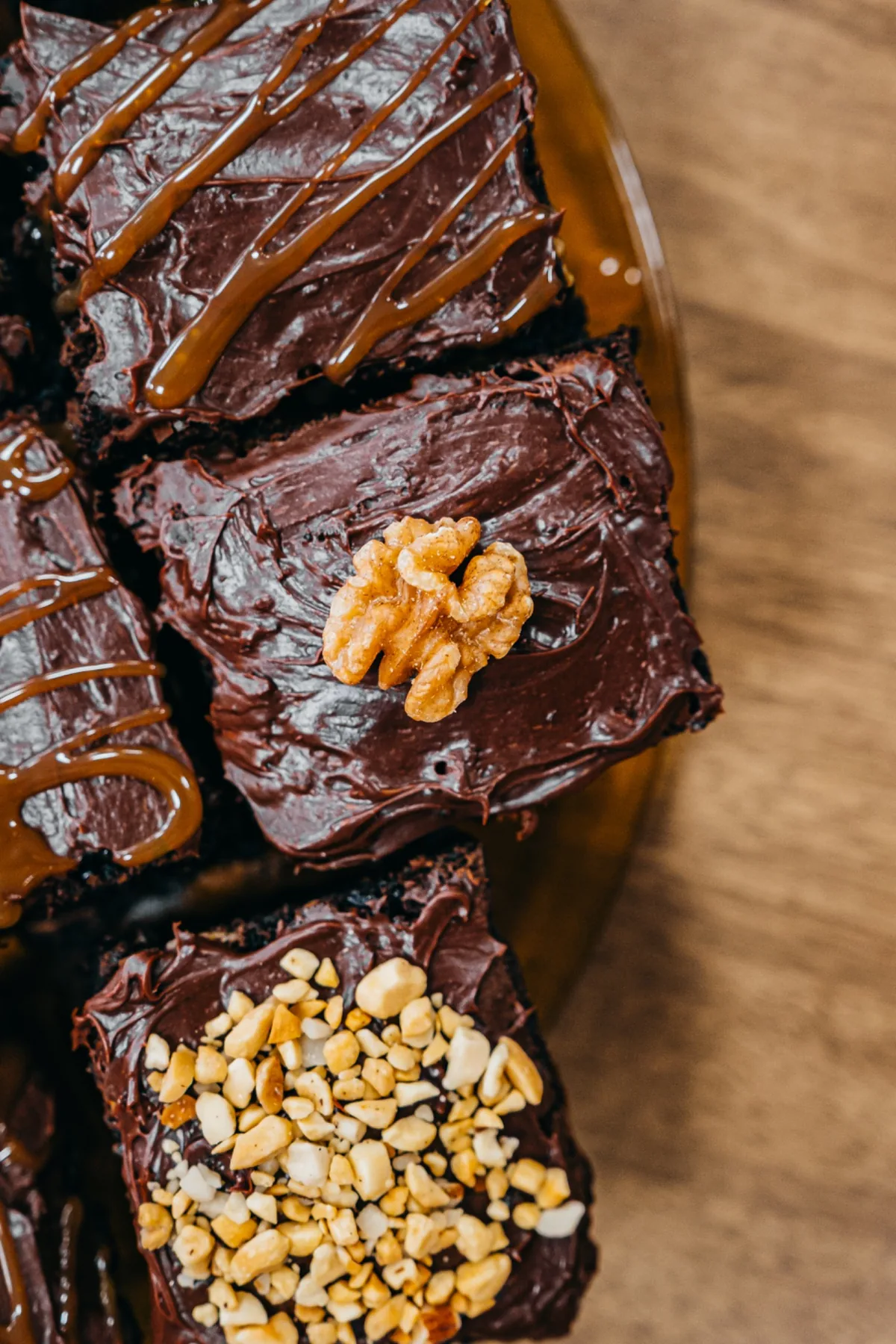 Chocolate brownie topped with walnuts and caramel drizzle.