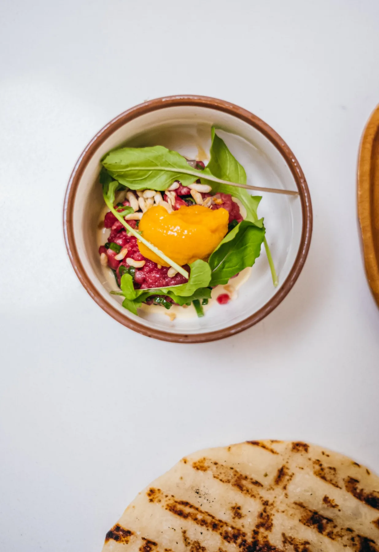 Colorful composed salad with greens, grains, and golden squash.
