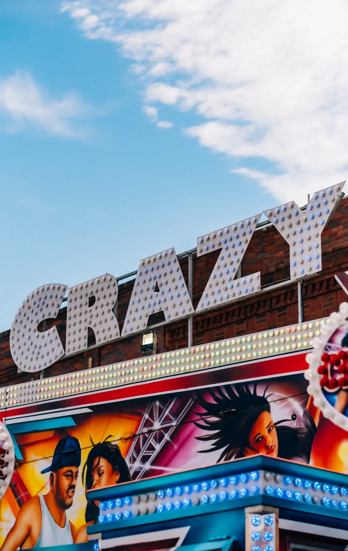 Bumper cars photographed through carnival railings.