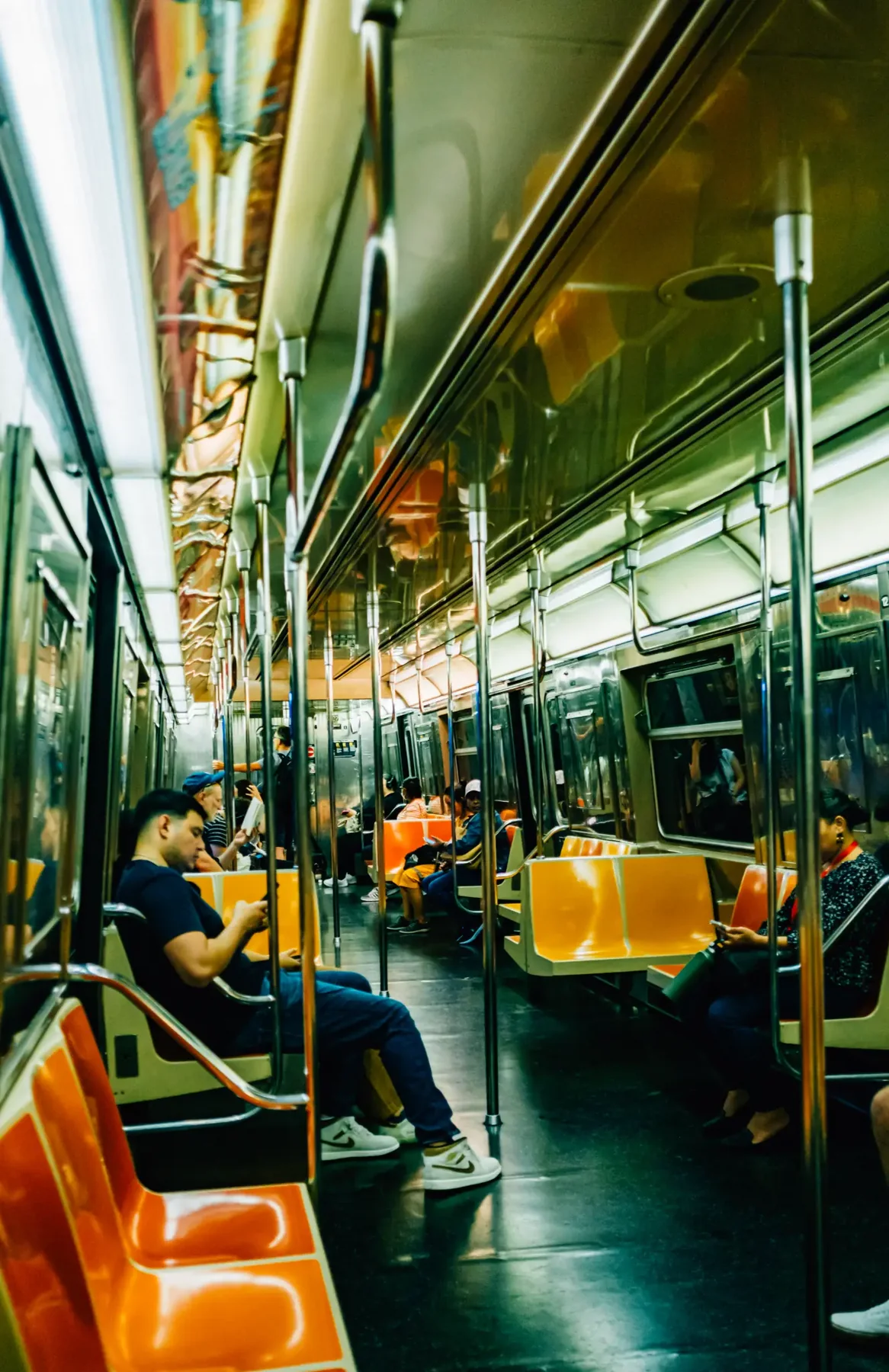Orange seats inside a New York City subway car.