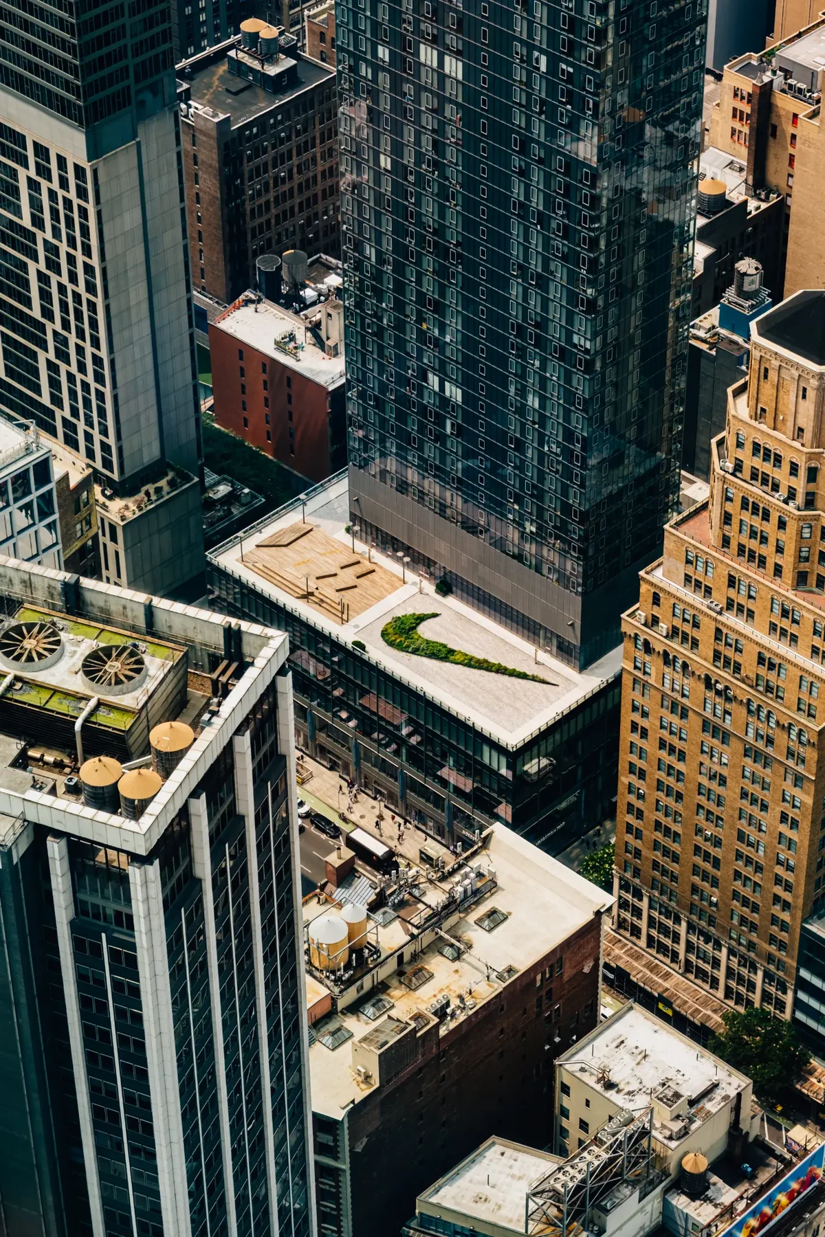 Aerial view of New York City rooftops, blocks, and traffic.