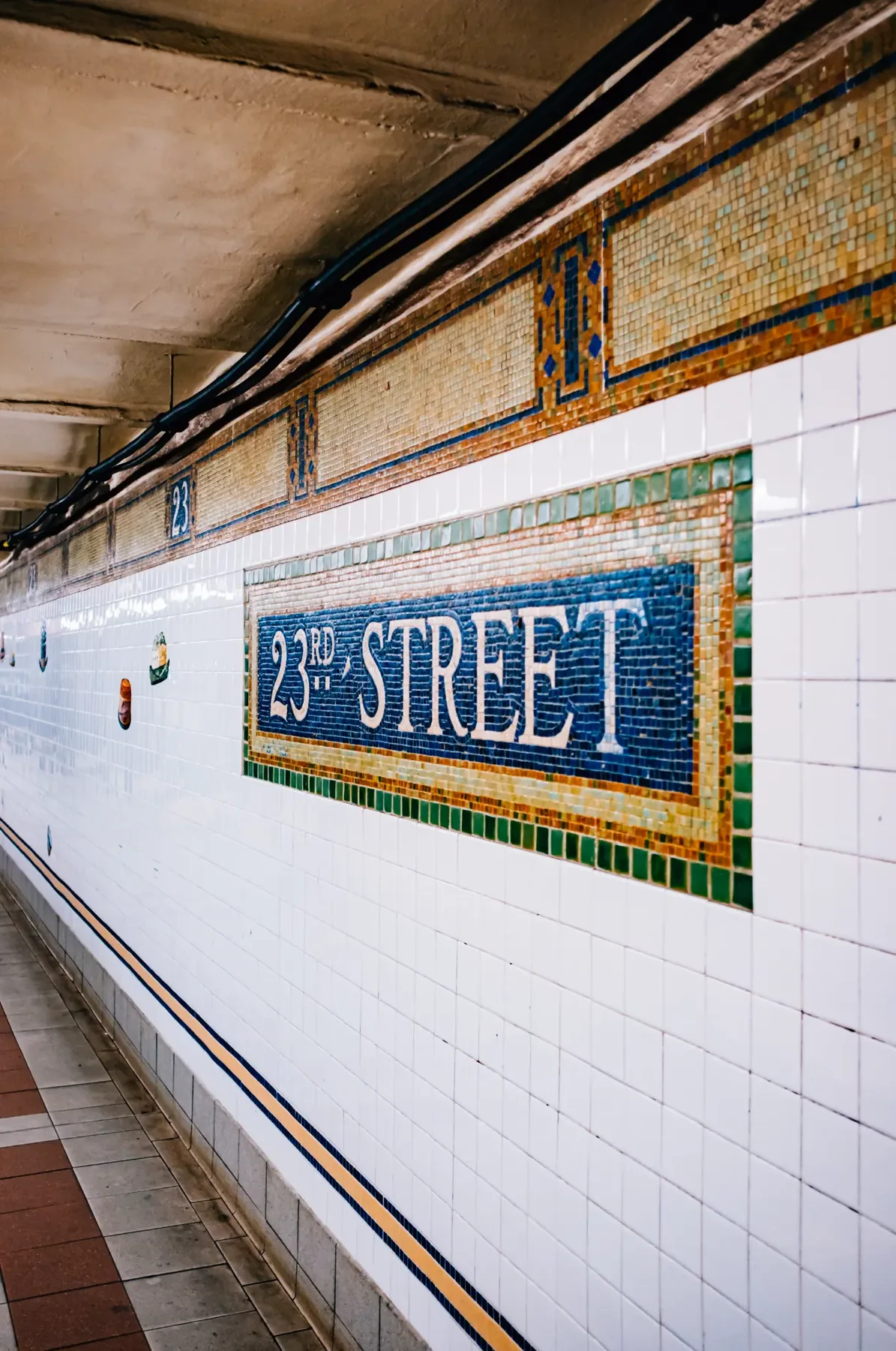 23 Street subway station sign and tiled platform.