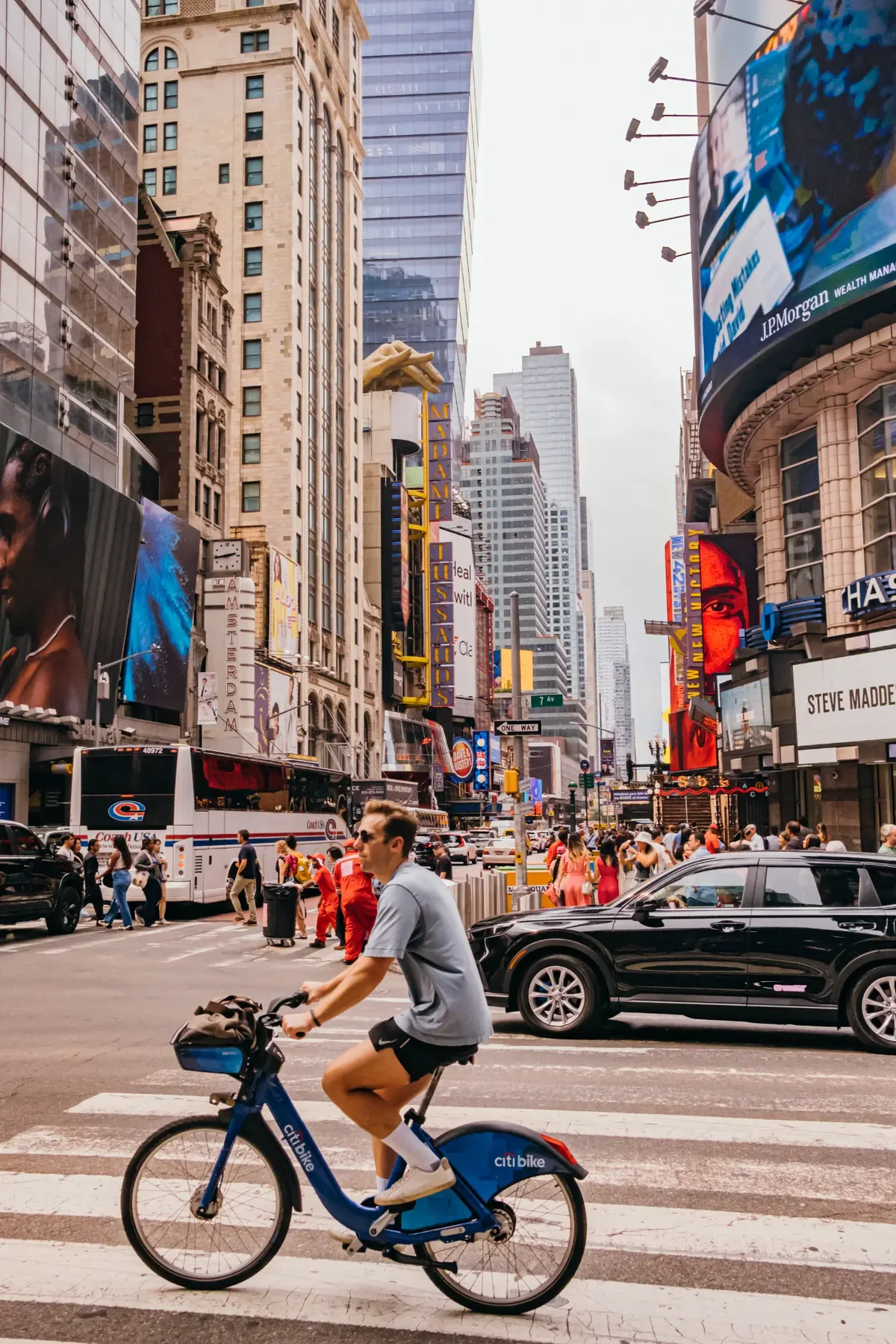Cyclist crossing a Times Square intersection.