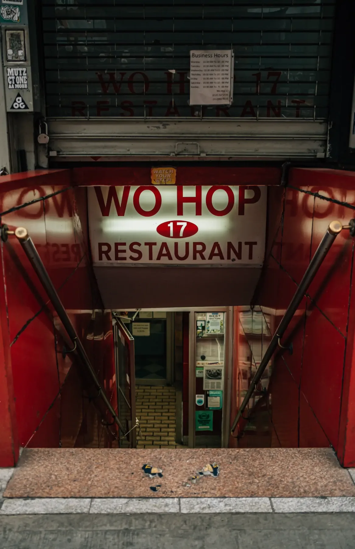 Red entrance of Wo Hop Restaurant in New York City's Chinatown.