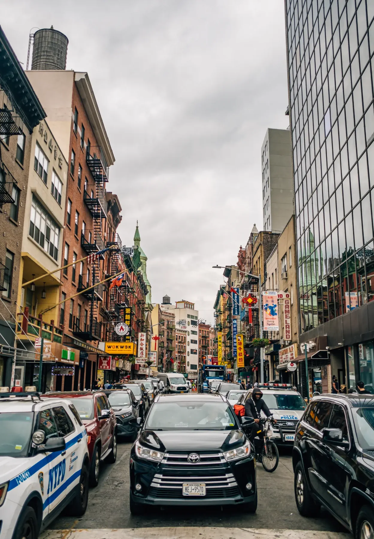 New York City avenue with taxis, traffic, and tall buildings.